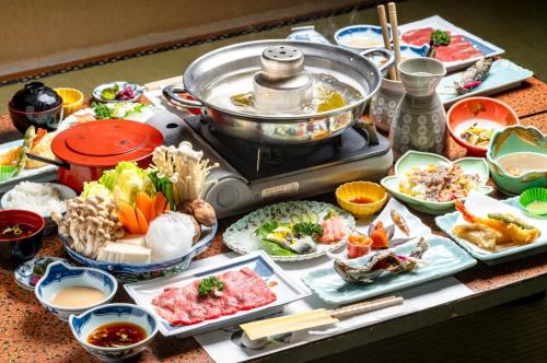 a table topped with plates of food and a pot of food at Yaki no Yu - Vacation STAY 29804v in Takayama