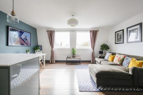a living room with a couch and a table at The Penthouses, 8 Albion Mews in Chester