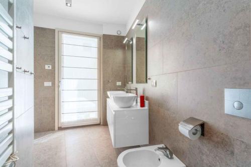 a bathroom with a sink and a toilet and a mirror at Townhouse in the heart of the city in Milan