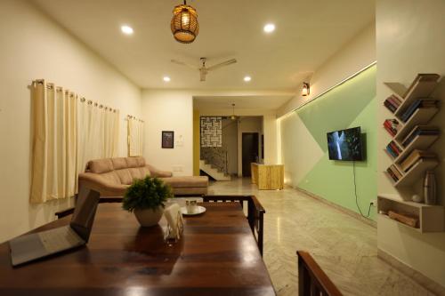 a living room with a table and a couch at Rostel Backpackers Hostel in Pune