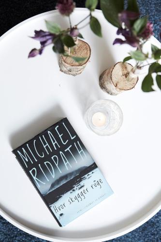 a book sitting on a white table with flowers at Hotel Skjern in Skjern