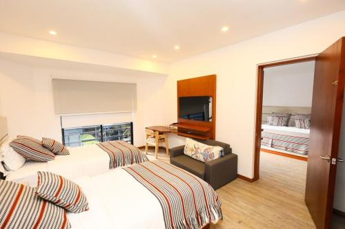 Ένα ή περισσότερα κρεβάτια σε δωμάτιο στο Two-Bedroom Executive Suite-Casa Pardo 4-7