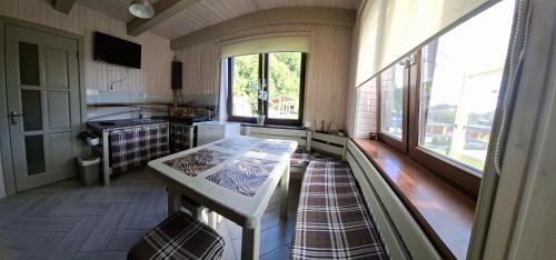 a kitchen with a table and some windows at Lucy in Yaremche