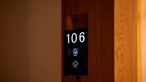 an electronic clock on the side of a door at Ava Hotel Prishtina in Pristina