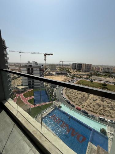 a view of a swimming pool from a building at Peaceful Cozy 1 BHK Pool Garden View Liwan Dubai Land in Dubai