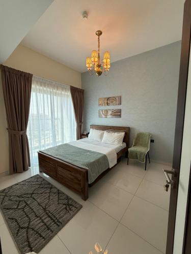 a bedroom with a bed and a chandelier at Peaceful Cozy 1 BHK Pool Garden View Liwan Dubai Land in Dubai
