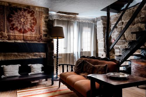 a living room with a couch and a table at Casa dos Candeias - Apartamento Tio João in Chaves