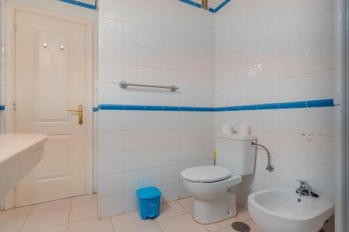 a bathroom with a white toilet and a sink at Appartment Zomero, SEAVIEW & WIFI & POOL in Costa Del Silencio