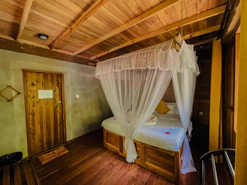a bedroom with a bed with a canopy at Habarana Tree House Ambasewana Resort in Habarana