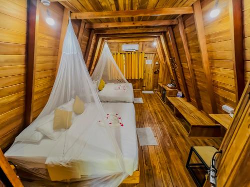 a bedroom with a bed in a wooden cabin at Habarana Tree House Ambasewana Resort in Habarana