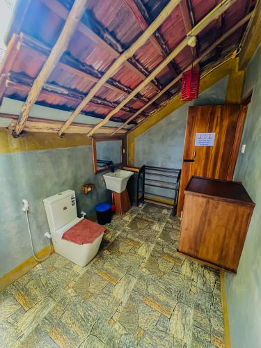 a bathroom with a toilet and a sink at Habarana Tree House Ambasewana Resort in Habarana