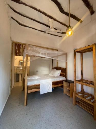 a bedroom with a bunk bed in a room at Zanzibar beach escape 1&2 in Bwejuu