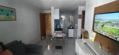 a living room with a flat screen tv on a wall at Impérium residence clube in João Pessoa