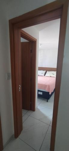 a door leading to a bedroom with a bed at Impérium residence clube in João Pessoa