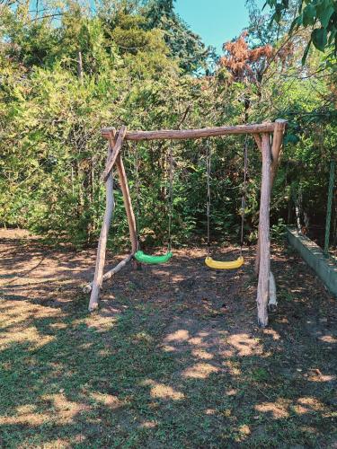 a playground with a swing and a swing at Csillag Vendégház Kiskunmajsa in Kiskunmajsa