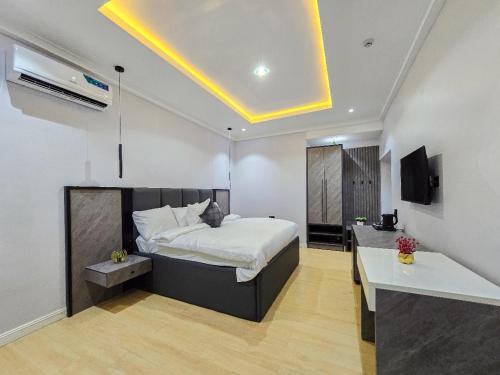 a bedroom with a bed and a desk in it at Twinny properties in Lagos