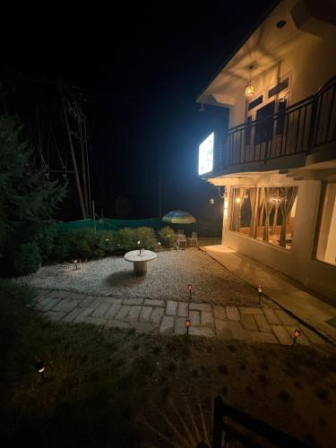 a night time picture of a building with a fountain in front at The Pahadi Soul Stay and Café in Jibhi