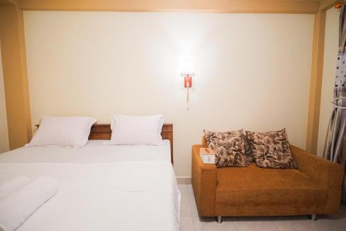 Ένα ή περισσότερα κρεβάτια σε δωμάτιο στο Natalia Homestay Ruteng