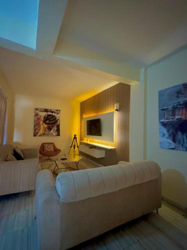a living room with a couch and a television at Apa signature 1bed and 2bed room Apartments Katampe main in Abuja