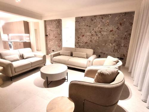 a living room with couches and chairs and tables at Karyatis Building in Nicosia