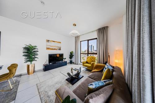 a living room with a couch and a tv at Lamtara 1 - Madinat Jumeirah Living, Jumeirah in Dubai