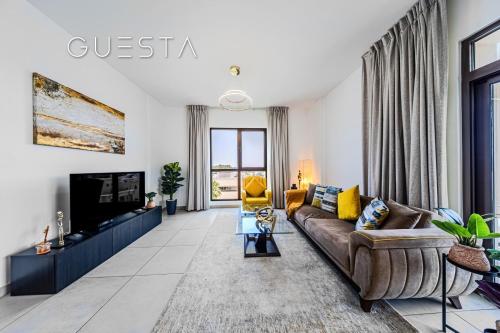 a living room with a couch and a tv at Lamtara 1 - Madinat Jumeirah Living, Jumeirah in Dubai