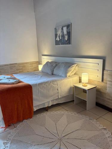 a bedroom with a bed and a small table at Hotel Villar in Penedo