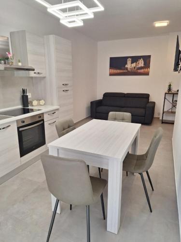 a kitchen and dining room with a white table and chairs at Il Nido a Due Passi da Assisi in Bastia Umbra
