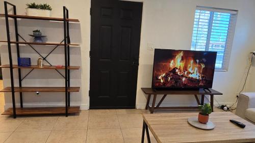 a living room with a tv sitting on a table at zzz Msg for 5 percent off zzz 3Bed 1Bath KingKingQueenBeds House MidtownPHX in Phoenix