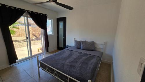 a bedroom with a bed and a large window at zzz Msg for 5 percent off zzz 3Bed 1Bath KingKingQueenBeds House MidtownPHX in Phoenix