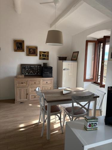 a kitchen with a table and chairs and a refrigerator at Castle Apartment with Lake View in Passignano sul Trasimeno