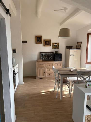 a kitchen with a table and a kitchen with a refrigerator at Castle Apartment with Lake View in Passignano sul Trasimeno