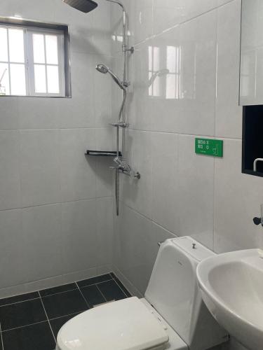 a bathroom with a shower and a toilet and a sink at Honey Bear Pension in Pyeongchang 