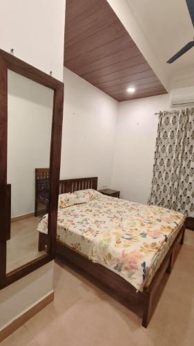 a bedroom with a bed with a large mirror at Umaid Niwas Homestay in Jaipur