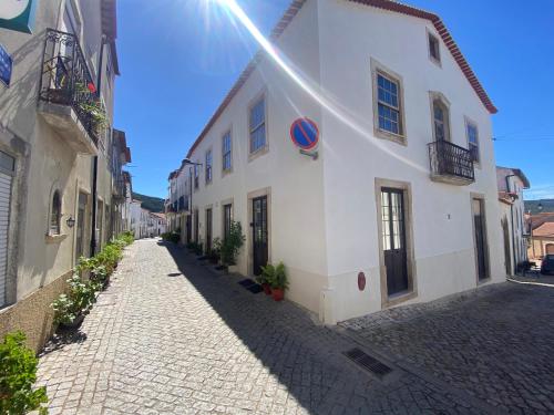 a cobblestone street in a town with a building at Casa lovits - Cozy One-Bedroom Apartment with Modern Comforts in Espinhal