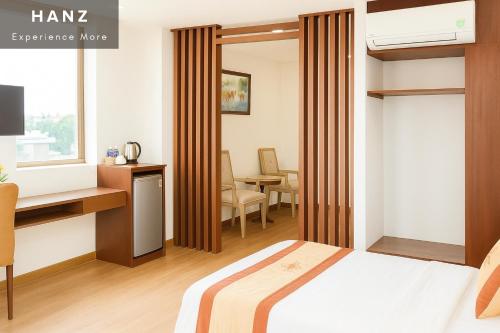 a hotel room with a bed and a desk and a desk at S79 Anh Duc Hotel in Ga Phú Văn