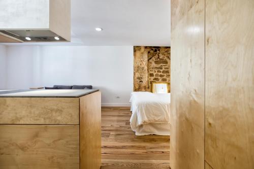 a kitchen with a counter and a bed in a room at Sant' Erasmo's Flat in Alghero