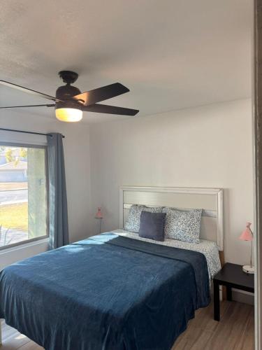 a bedroom with a blue bed and a ceiling fan at Msg for 5off 3Bed2Bath KingKingQueenBeds N PHX in Phoenix