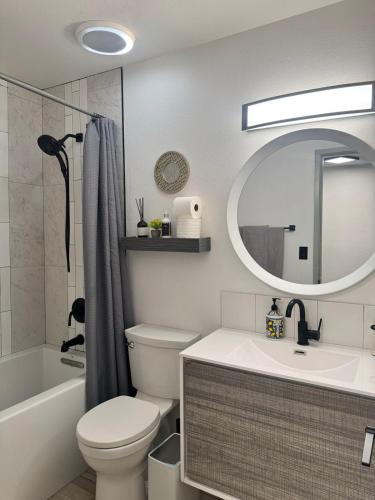 a bathroom with a toilet and a sink and a mirror at Msg for 5off 3Bed2Bath KingKingQueenBeds N PHX in Phoenix