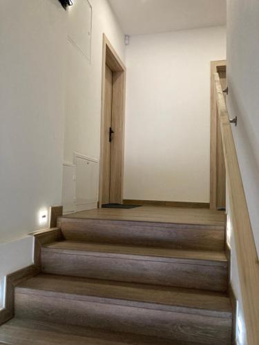 a room with stairs with a door and a hallway at Apartmán29 in Nové Mesto nad Váhom