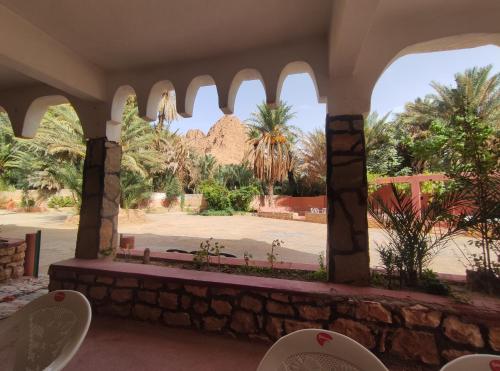 a view of the desert from a building with chairs at Le LAC Auberge Camping Todra in Tinerhir