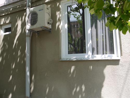 a building with a window and a air conditioner at Family Hotel Mountain Scream in Tbilisi City