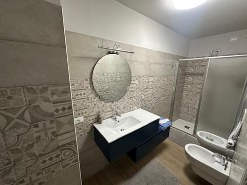 a bathroom with a sink and a shower at La casa di Amelie in Flero