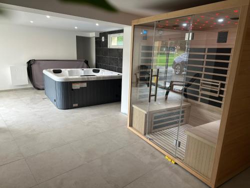 a bathroom with a tub and a sink in a room at Nouveauté Gite la virée verte in Vagney