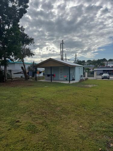 a white building with a grass field in front of it at Ostiones Beach Property in Garita