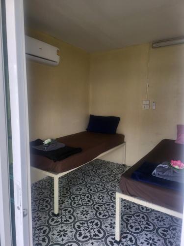 a small room with two beds in a room at KiKi HOSTEL in Haad Rin