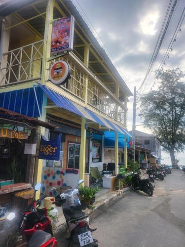 a building with motorcycles parked in front of it at KiKi HOSTEL in Haad Rin