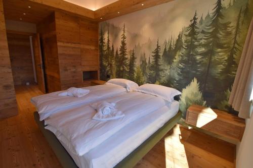 Letto o letti in una camera di BRENTA ALTA ALPINE LODGE MhD