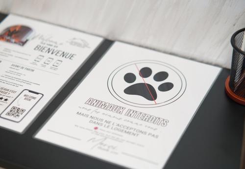 a white card with a paw print on it at 5 min drive from Train Station with Parking, Air Conditioning & IPTV -Ideal for CAN 2025 in Kenitra