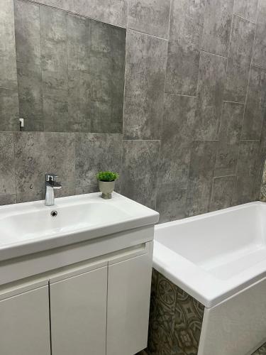 a bathroom with a sink and a bath tub at ЖК Green Plaza Aktau Двухкомнатная большая in Aktau